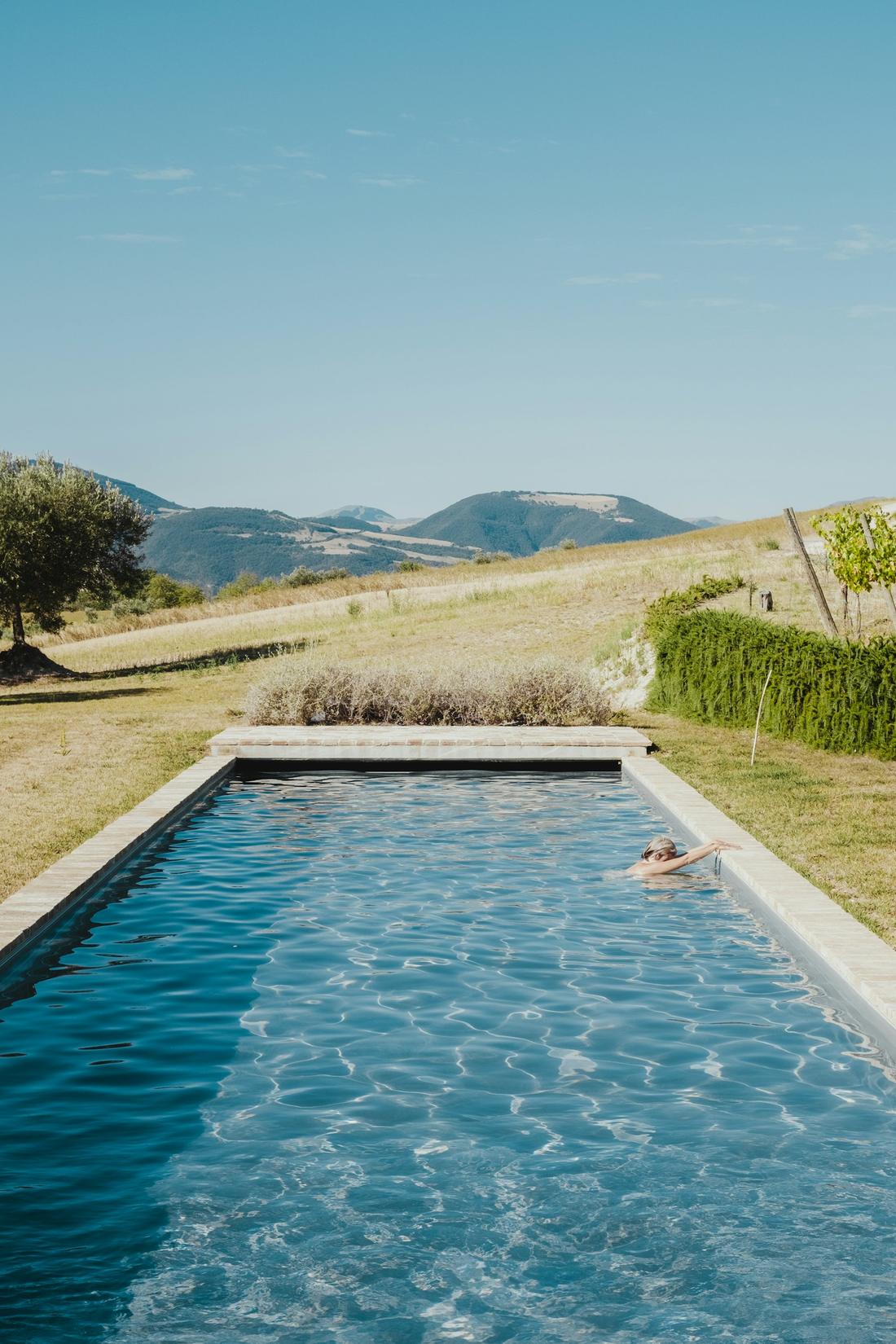 A long lap pool with dry hills behind